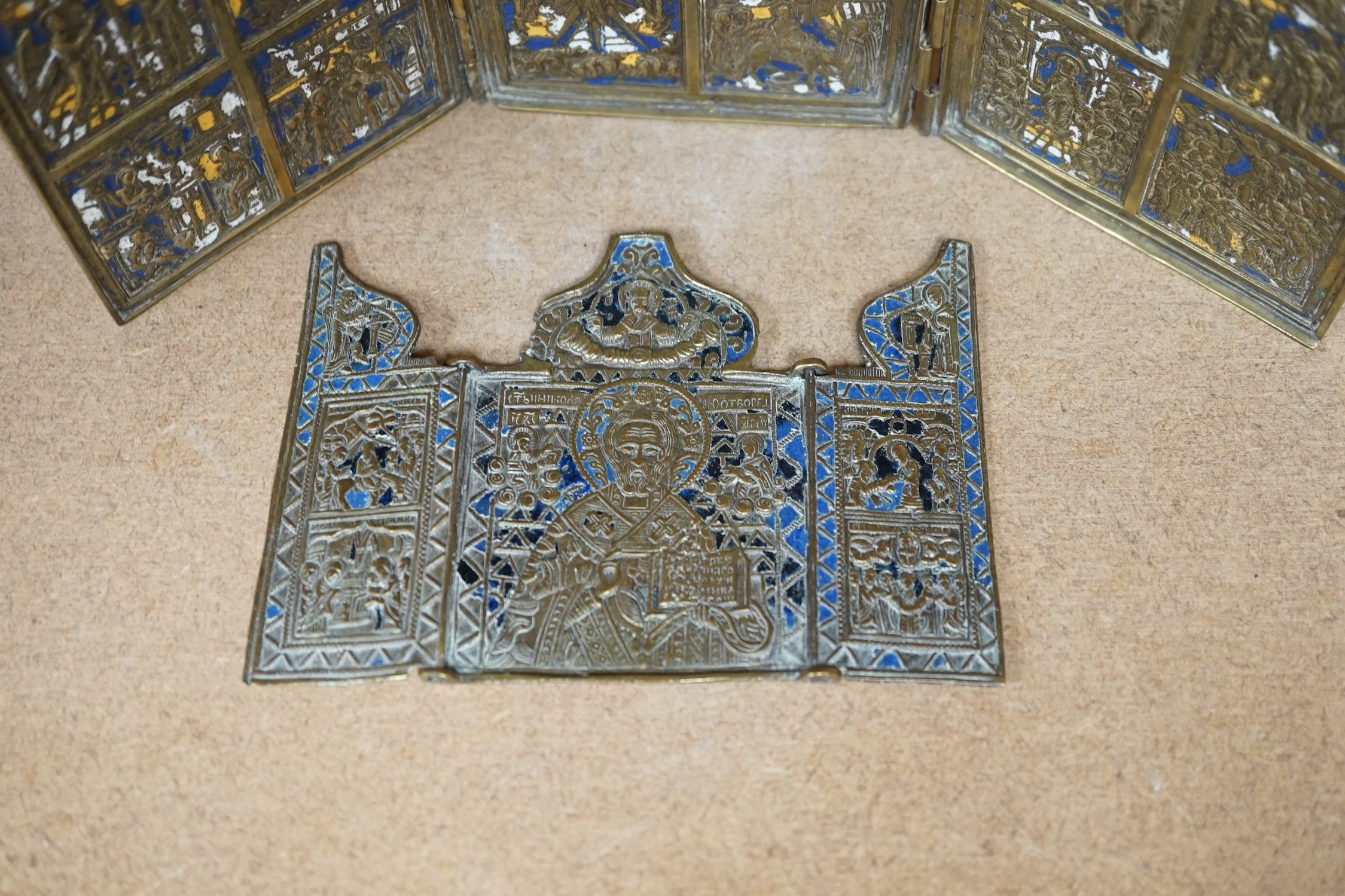 Two Russian Orthodox Church bronze and enamel triptych icons, largest 11cm high. Condition - fair